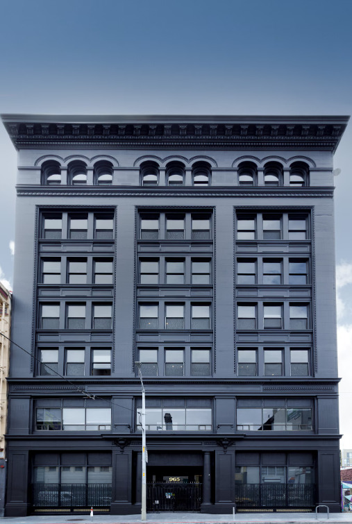 The historic facade of 965 Mission Street with arched windows along the top floor